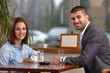© bokan - Young business couple sitting in a cafe enjoying their coffee break
