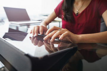 Woman using tablet computer for daily work in office