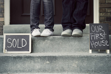 couple on doorstep of new home