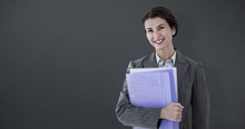 Composite Image Of Businesswoman Holding Folders