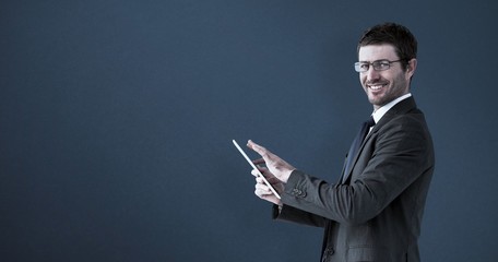 Canvas Print - Composite image of businessman using his tablet pc 