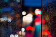 Rain on glass and bokeh of car lights in traffic 