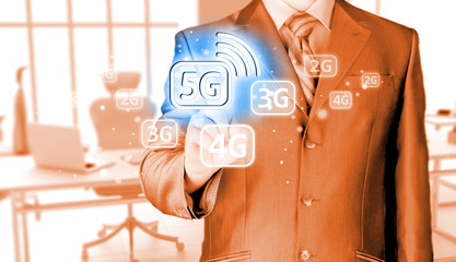 Wall Mural - businessman holding in hand 5G, technology background