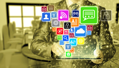 Business man using tablet PC with social media icon set