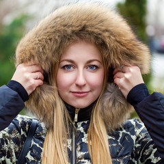 Wall Mural - Young beautiful blonde woman in fur hood