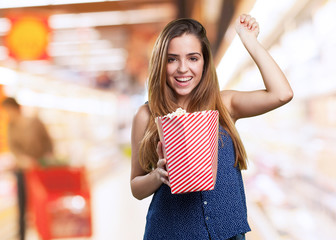 Wall Mural - young cute woman holding popcorn