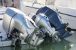 A row of three outboard engines in rest at port