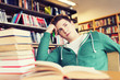 © Syda Productions - bored student or young man with books in library