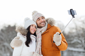 Poster - happy couple taking selfie by smartphone in winter