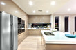A modern kitchen with refrigerator and fixed to the wall with ca