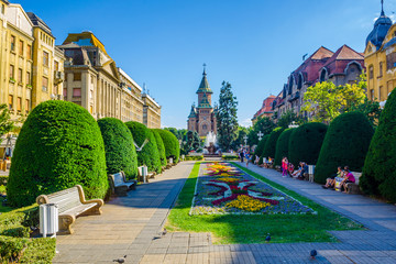 Victory square - piata victoriei - timisoara is a long square with green park surrounded by national opera on one side and the metropolitan cathedral on the other.