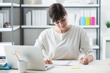 Poster - Young designer sketching on a notepad