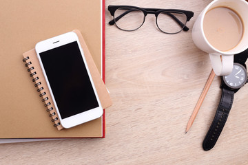 Wall Mural - smartphone on book and glasses on wooden background