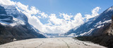 Fototapeta Góry - hikers on a glacier in the middle of peaks of the rocky mountains of alberta canada