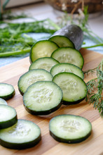 Fresh Cucumber Slices Arranged With Dill Portrait Side Low