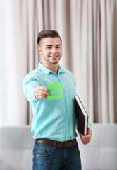 Poster - Friendly male estate-agent on light background