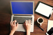 © Africa Studio - Modern tablet, mobile phone, coffee cup and female hands using laptop, on the wooden background