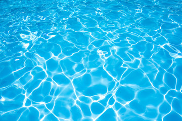 ripple water in swimming pool with sun reflection