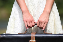 A Female Hand With A Suitcase