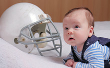 Baby Boy And American Football Helmet. Want Be Like Father Concept