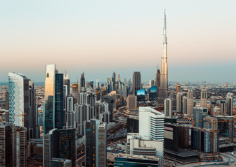 Wall Mural - Fantastic roofftop view of Dubai's business bay towers at sunset. Modern architecture and travel background.