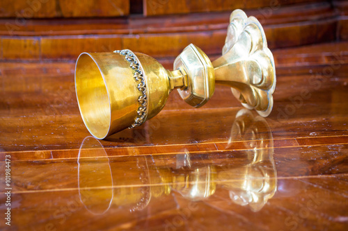 Fotografie, Obraz Golden grail turned on wooden background
