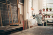 © mavoimages - Positive business owner on phone in his workshop