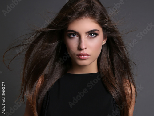 Fotografie, Obraz gorgeous sensual woman with dark straight hair wears elegant clothes