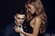 fashion studio photo of impassioned beautiful couple. sexy woman with blond hair and handsome brunette man