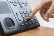Телефон в офисе и палец на кнопке