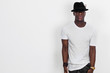 Handsome and cool african man portrait wearing shirt and hat