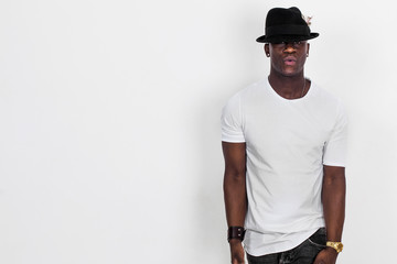 Handsome and cool african man portrait wearing shirt and hat