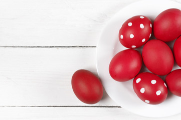 Red Easter eggs in plate