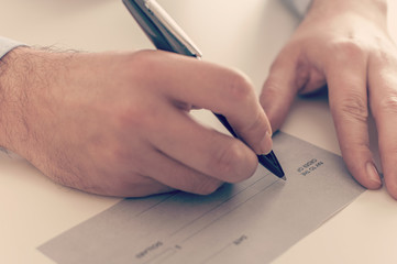 Businessman writing a payment check