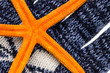 orange sea star lies on knitted glove