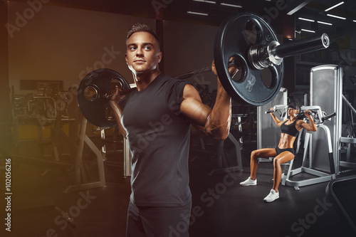 Naklejka na meble Young and fit couple in the gym doing workout