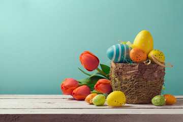 Wall Mural - Easter egg decorations with flowers over blue background