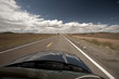scenic view from car on long lonely old asphalt road Route 66 and blue sky, USA