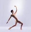 © Acronym - Athletic ballet dancer in a perfect shape performing over the grey background.