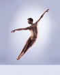 © Acronym - Athletic ballet dancer in a perfect shape performing over the grey background.