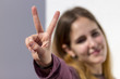 © Alonso Aguilar - Young woman showing the sign of victory or peace