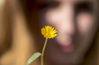 © Alonso Aguilar - A girl showing a little yellow flower