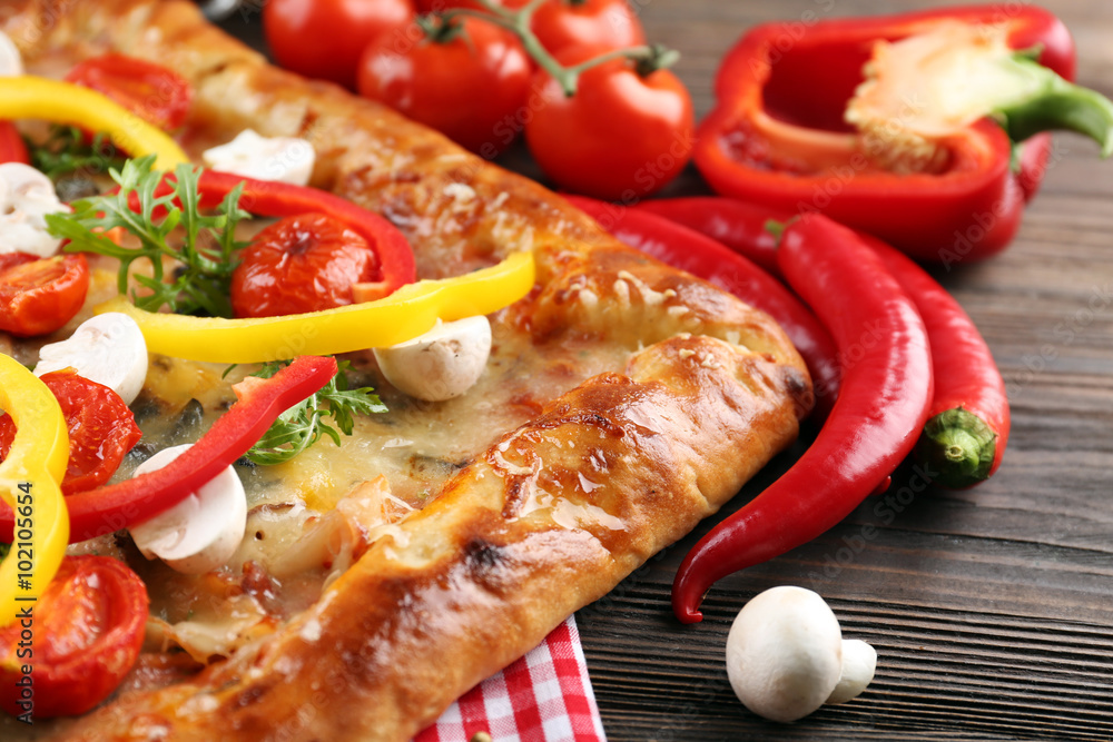 Freshly homemade pizza on wooden table closeup