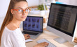 © shefkate - Young woman working in office, sitting at desk