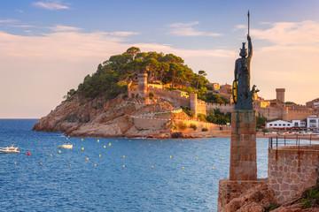 Wall Mural - Statue of Minerva on the enbankment, Fortress and Badia de Tossa bay in Tossa de Mar on Costa Brava at summer sunset, Catalunya, Spain