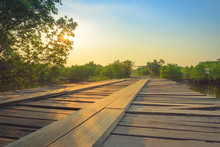 Wooden Bridge In The Countryside Crossing The River At Sunset. S