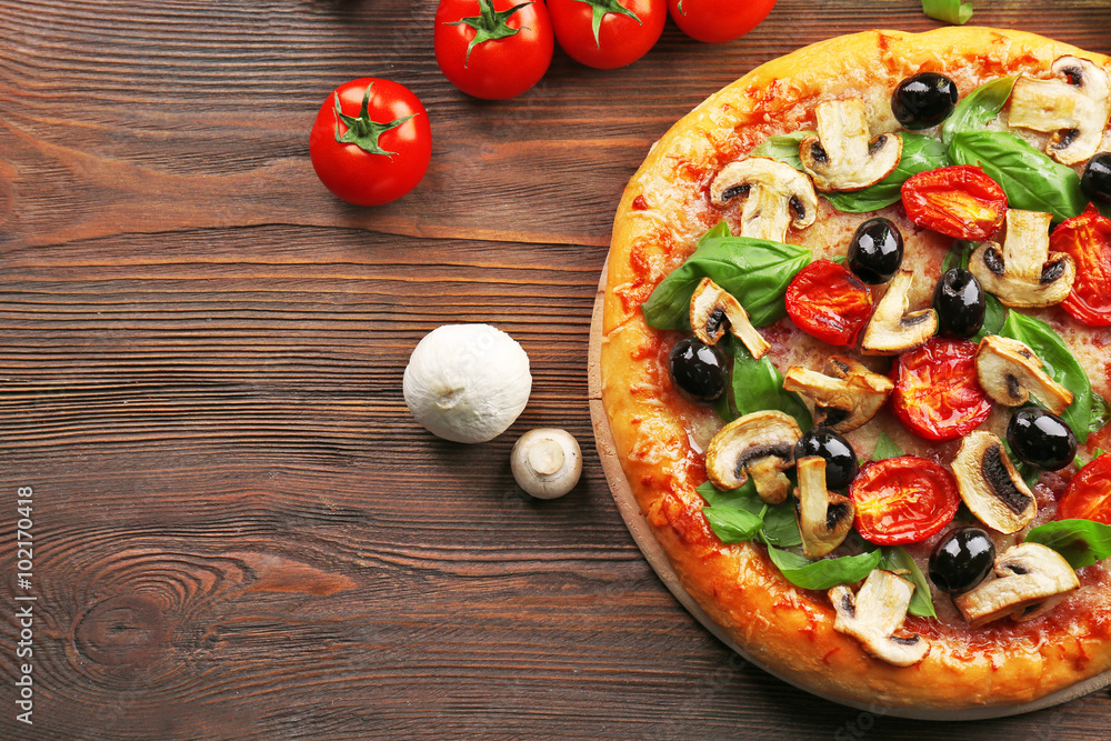 Delicious tasty pizza with ingredients on wooden table