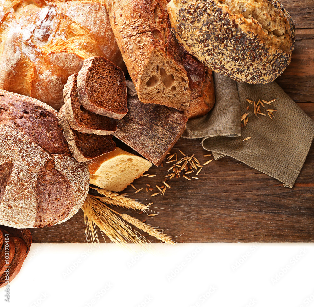 Fresh baked bread and wheat ears, isolated on white
