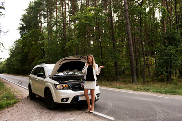 Wall Mural - Young woman with broken car calling for help