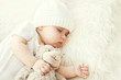 Cute baby sleeping on white bed at home closeup